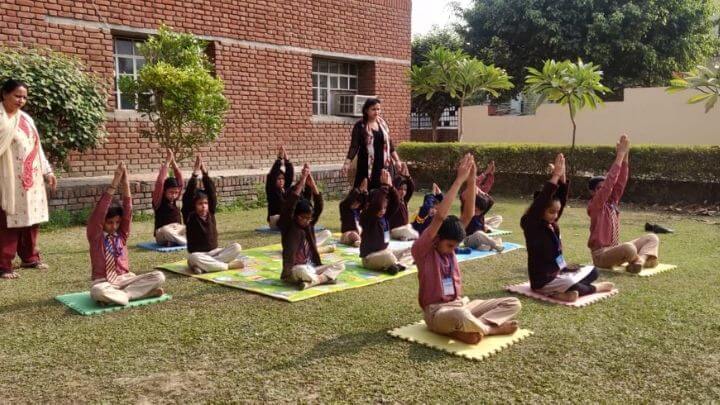 students performing yoga at nimt school ghaziabad